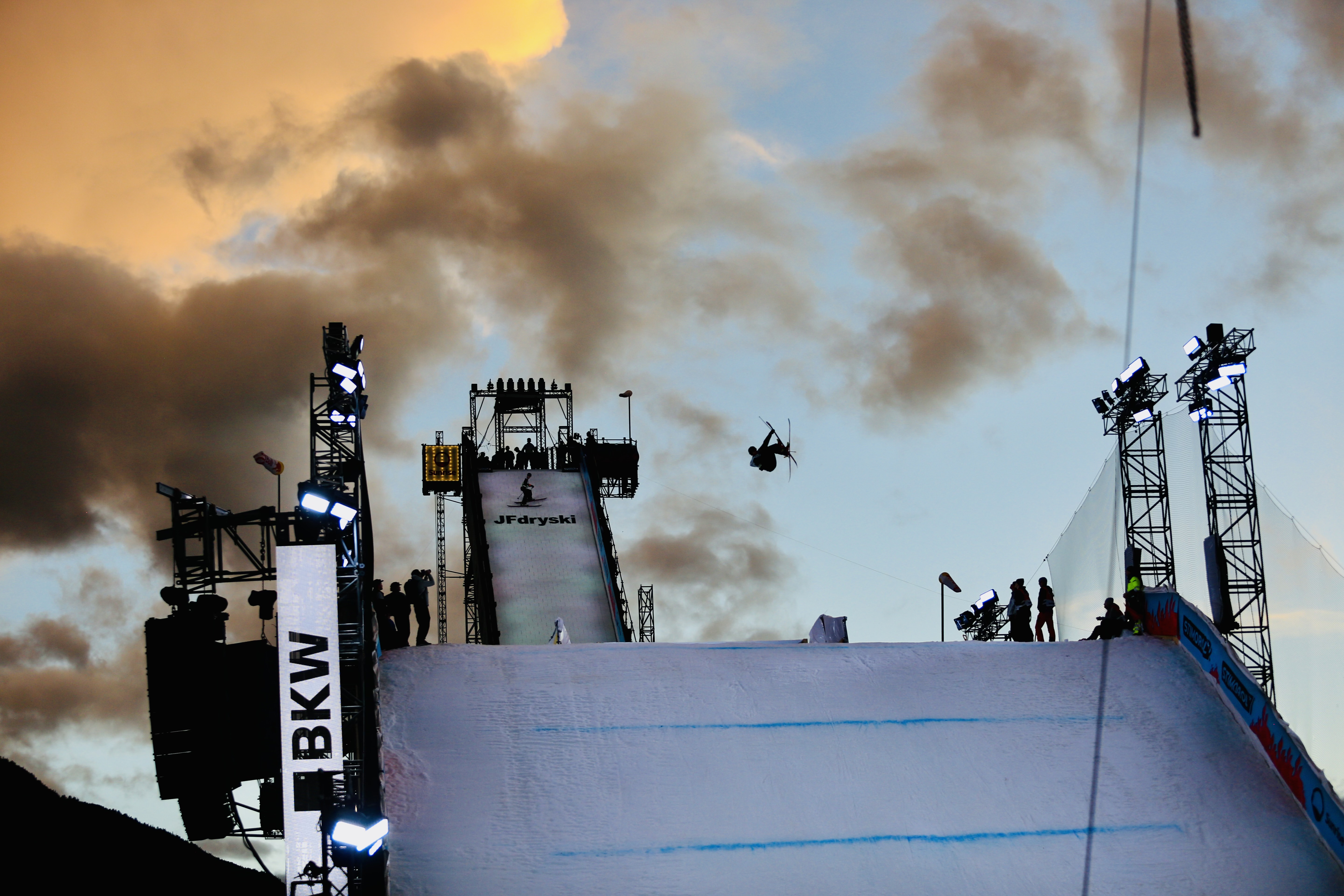 Troy Podmilsak in mid-air during Big Air training at sunset in Chur, Switzerland