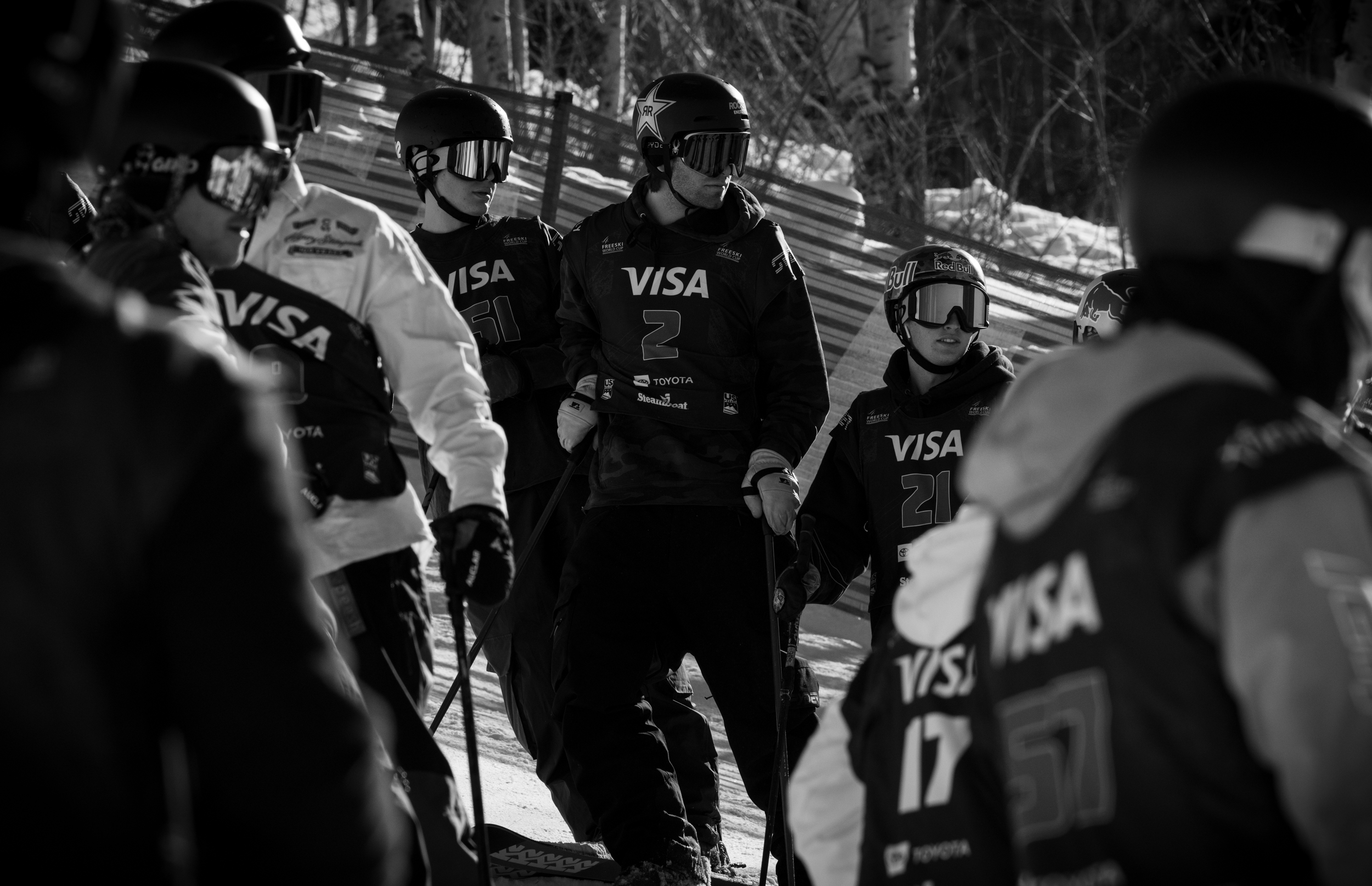 Three competitors watch the event.