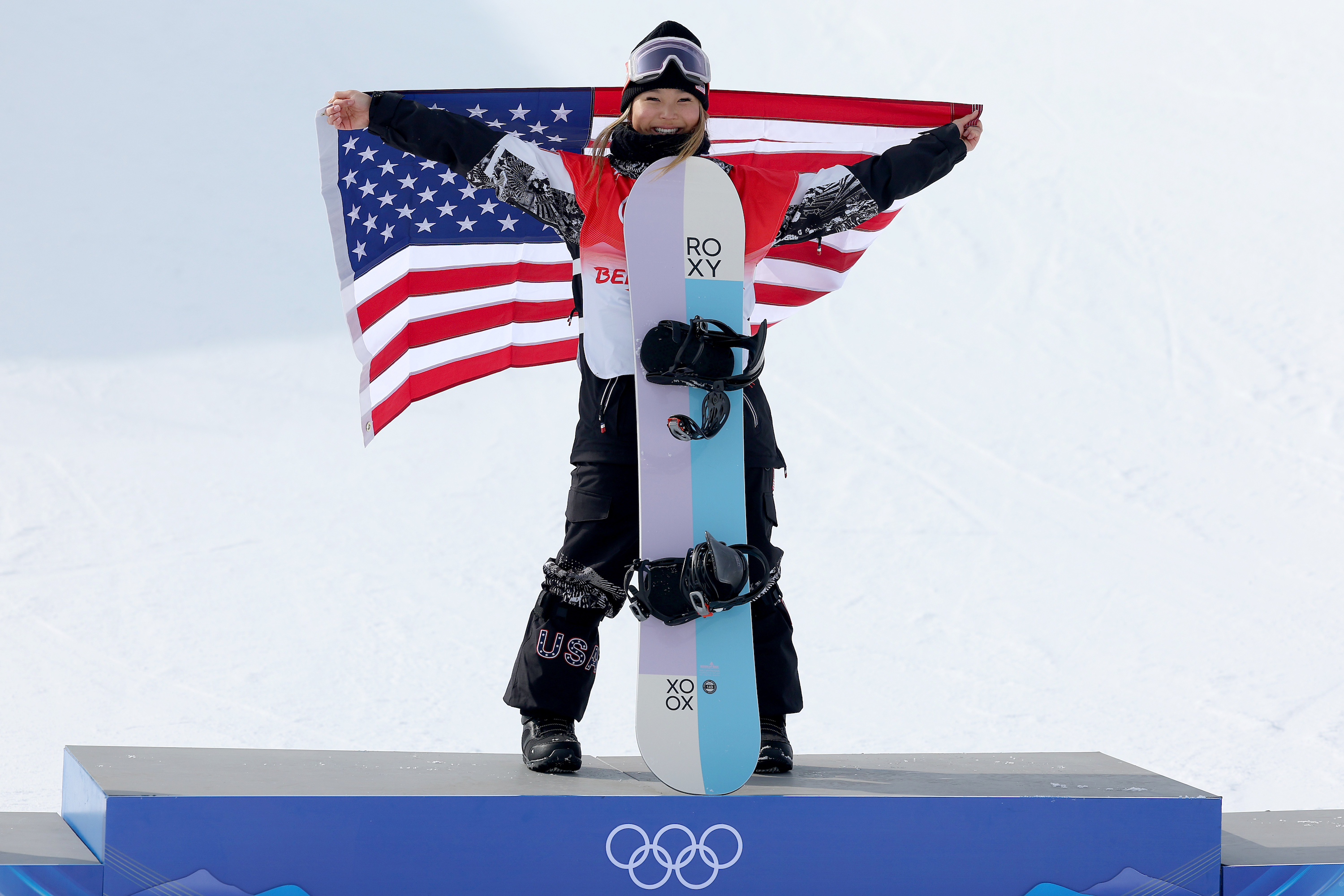 Chloe Kim stands at the top of the podium.